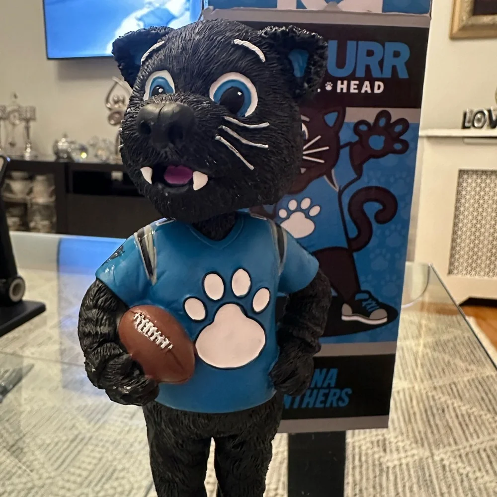The item in the image is a Sir Purr Carolina Panthers mascot figurine/statue.